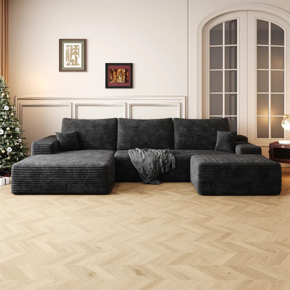 Comhoma 107-inch Cloud Sectional Sofa with Ottoman in dark grey plush corduroy, styled in a bright living room with light wood parquet flooring