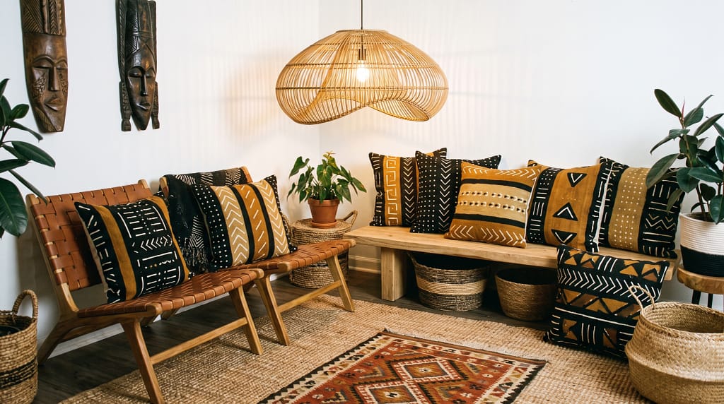 Afrohemian living room with woven wall baskets, layered textiles, earthy tones and natural wood furniture